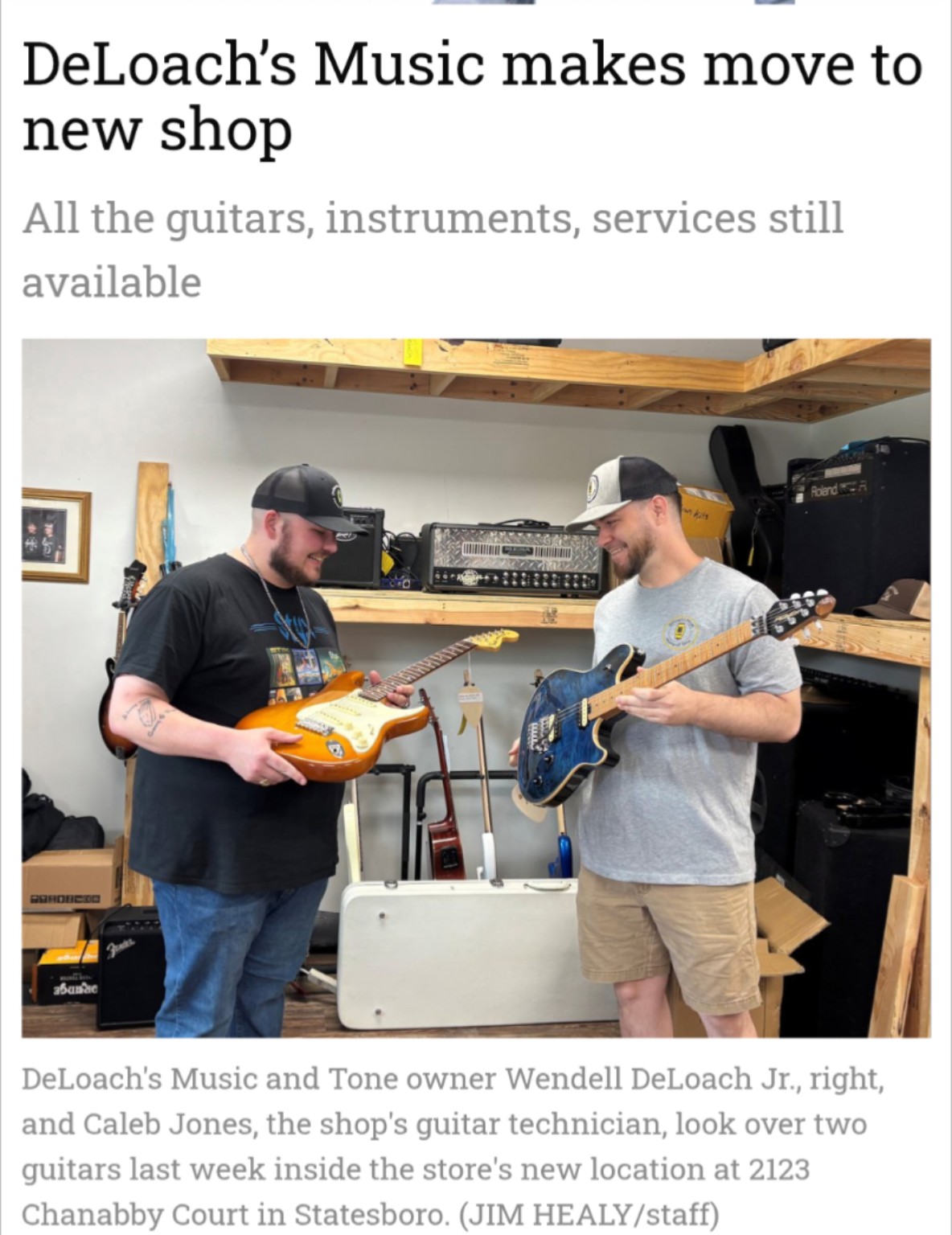 Statesboro Herald article screenshot showing the shop owner and guitar technician examining two guitars, with the original caption and photo credit
